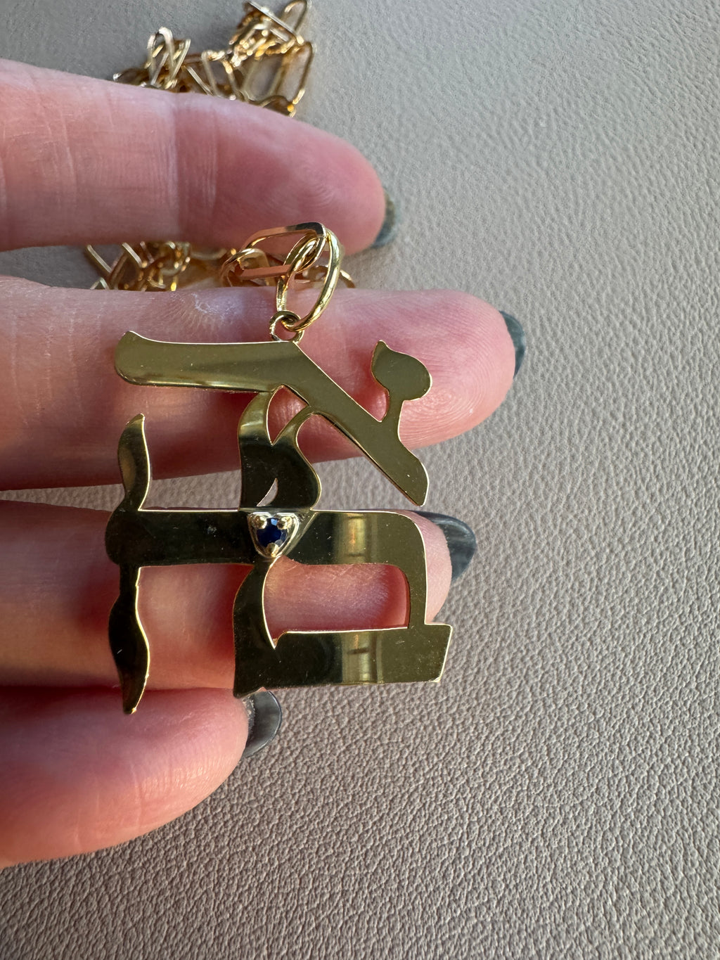 Gold plated large Ahava pendant with natural sapphire